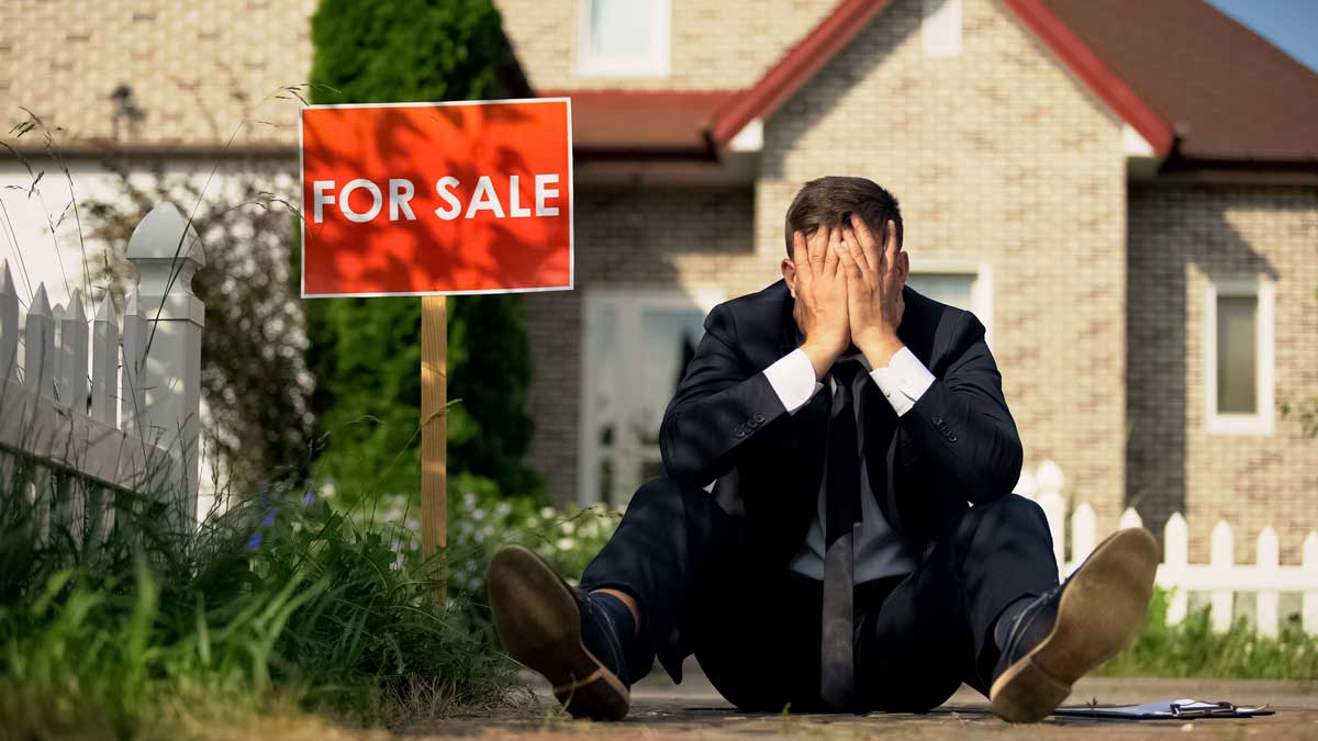 real estate agent on grass depressed